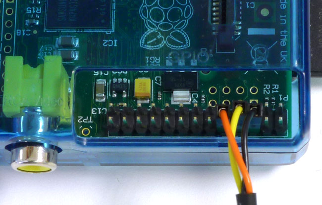 The Pi's UART pins connected: yellow and red for UART in and out, and black for 0V ground.